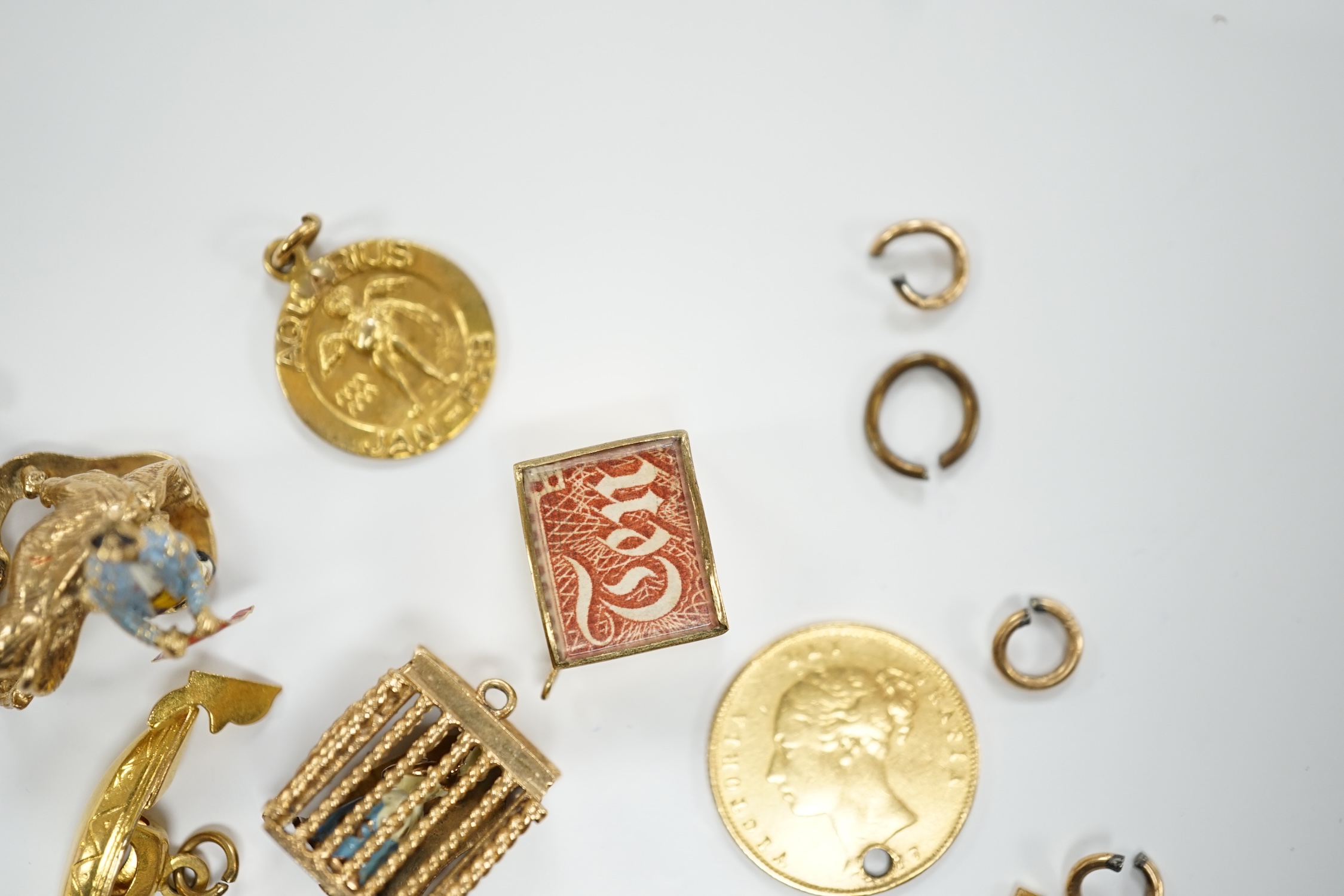 A 9ct gold curb link bracelet and eleven assorted mainly 9ct gold loose charms